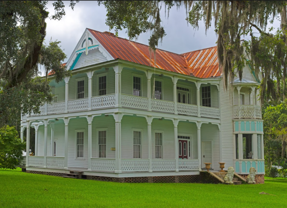 White Victorian house with deep porches, the Frank Saxon House, built 1870s