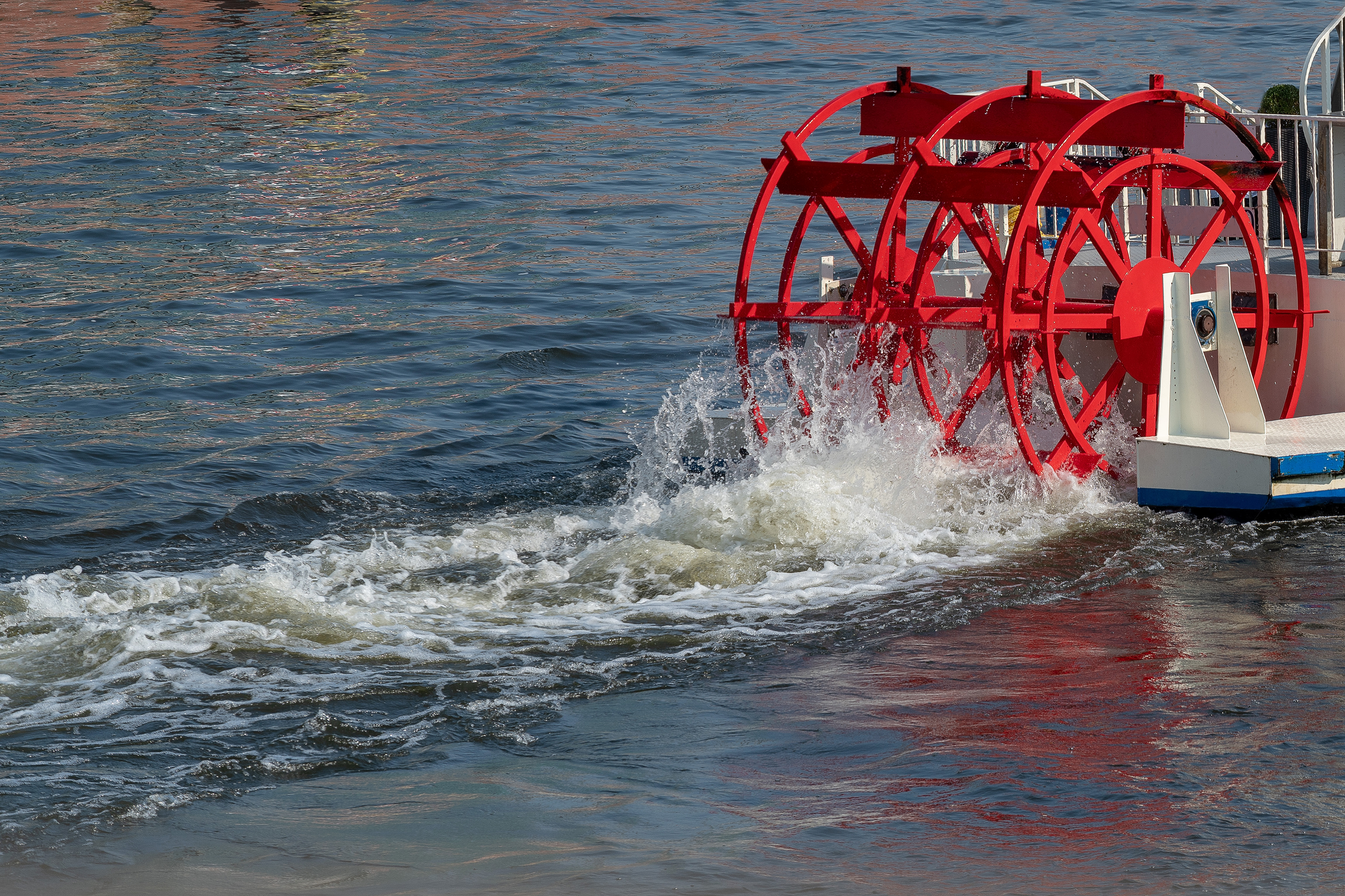 Red Paddlewheel on a boat in motion