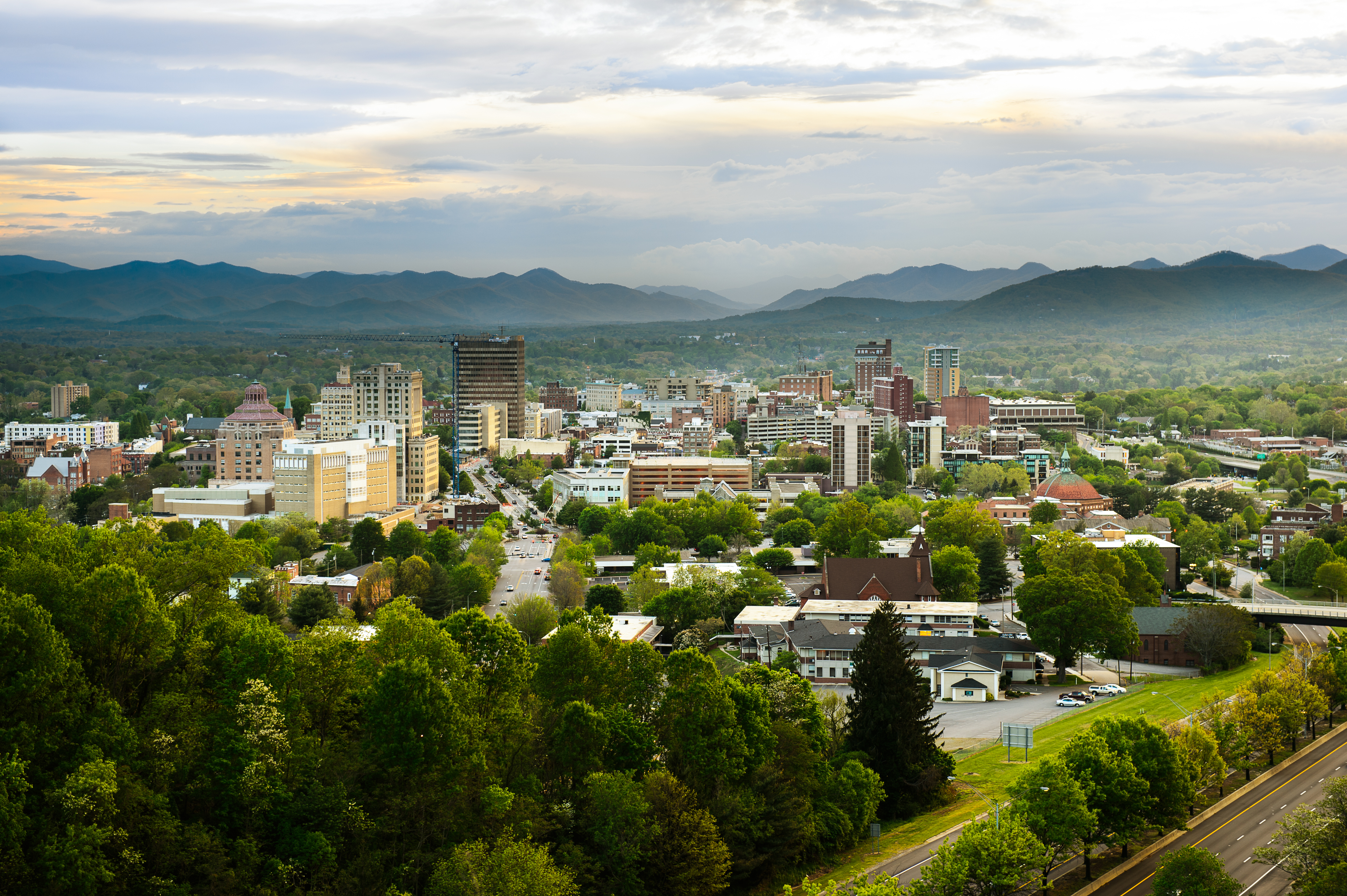 Aerial view of Asheville with mountains in background