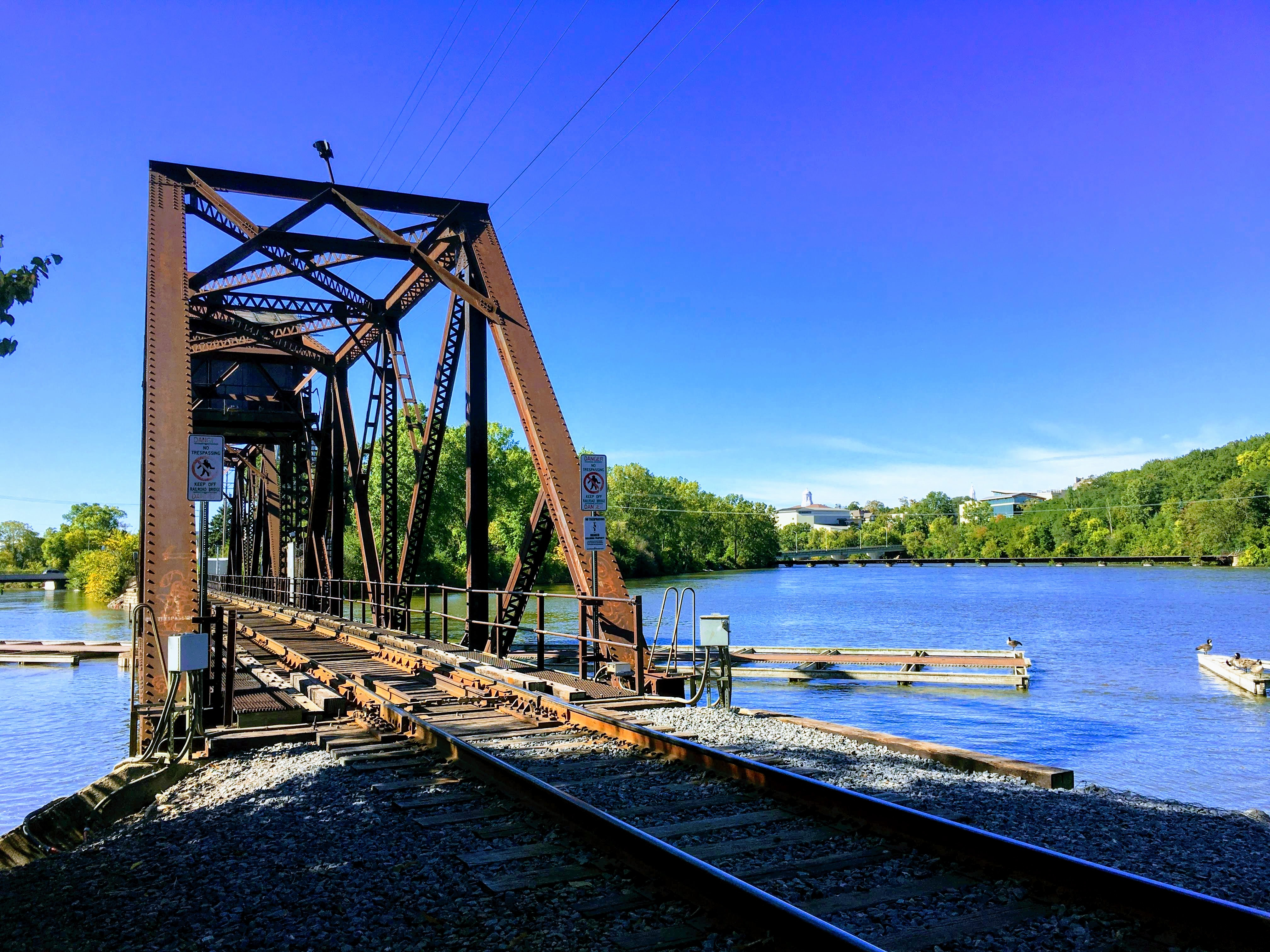 Rusted railroad bridge over a lake