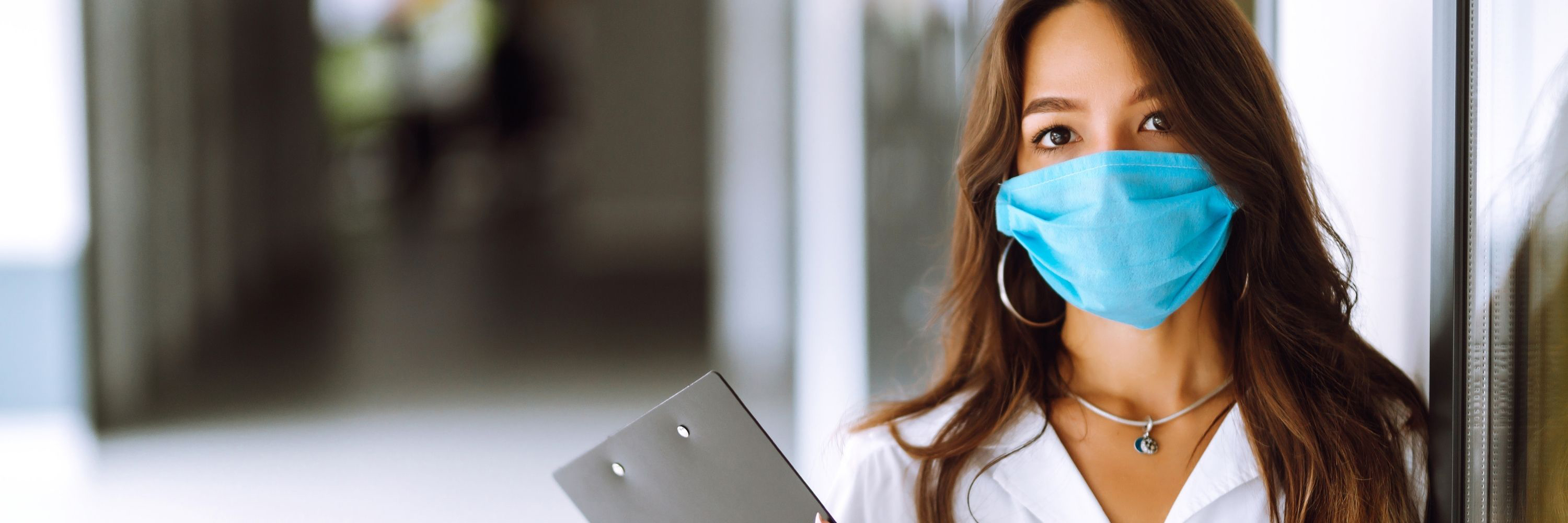 A healthcare worker in a blue face mask