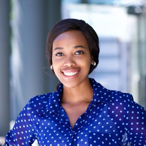 Woman in a blue shirt smiling at the camera