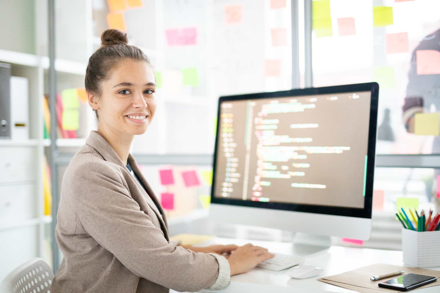 programmer-analyst-woman-seated-at-desk