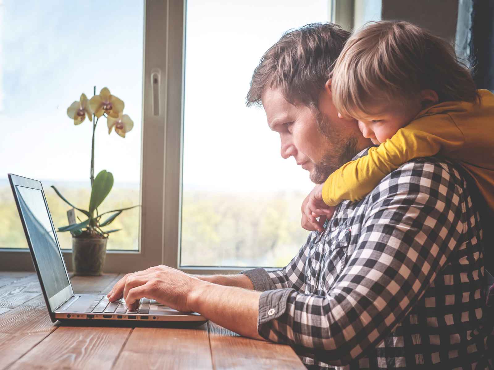 Father and son working on laptop