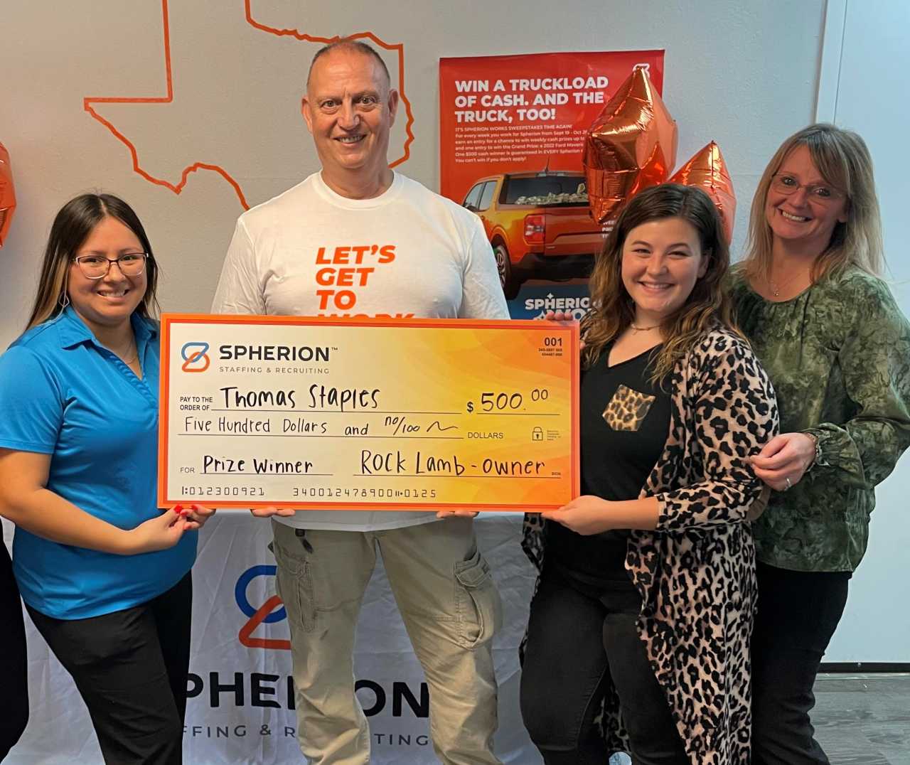 Employees from the Spherion Jacksonville, Texas office helping a $500 prize winner hold up a giant Spherion check