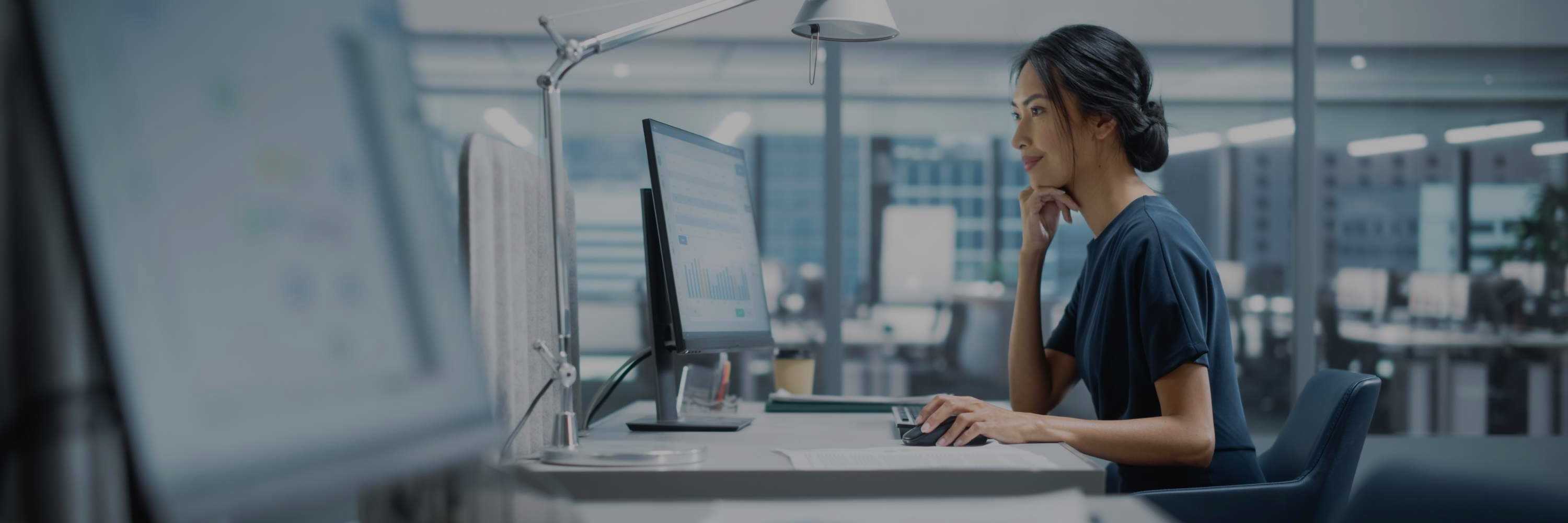 IT professional smiling while working at a computer