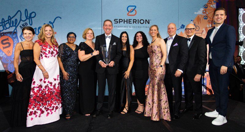 Spherion executives and franchisees dressed up on a stage to accept an award