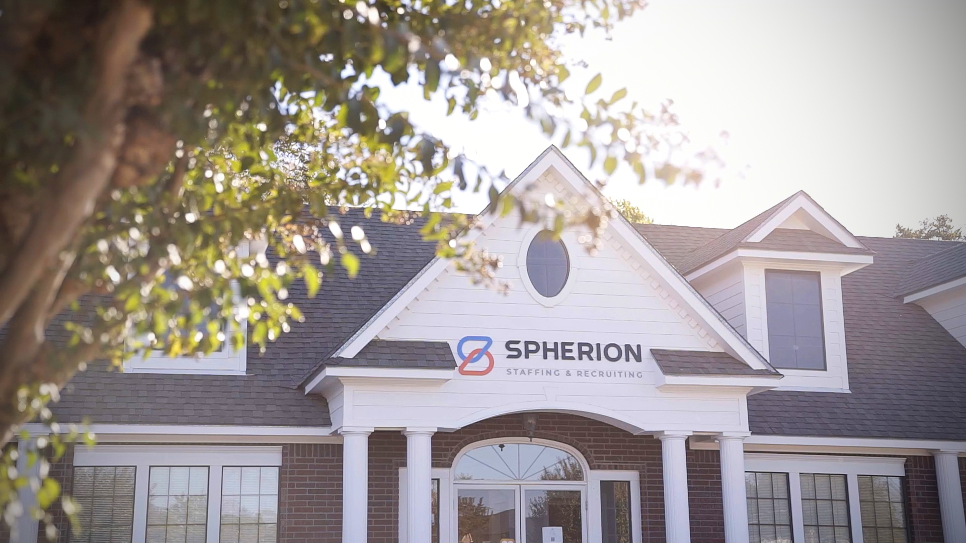 Photo of a Spherion office surrounded by trees and sunlight