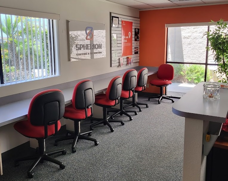 Photo of an office interior with six chairs pulled up to a counter