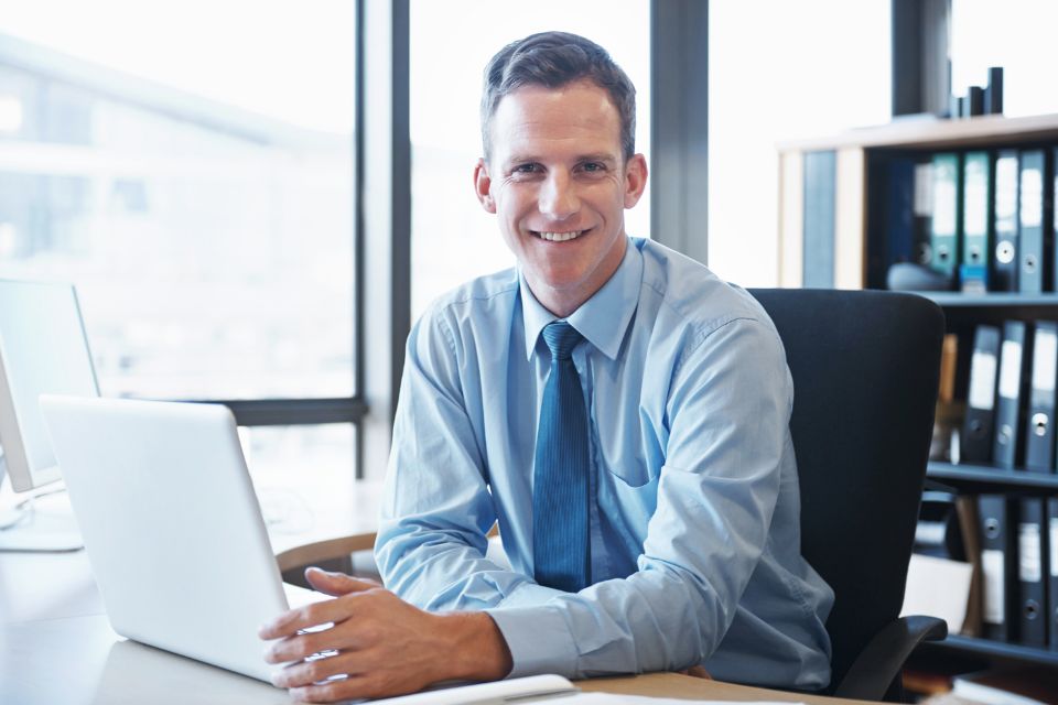 A man sitting at a desk in a professional office setting