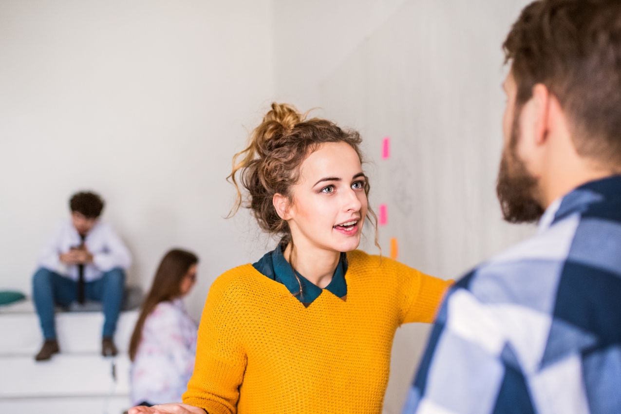 Woman talking with a man in an office setting