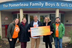 The Spherion Vermont team poses in front of the Pomerleau Family Boys and Girls Club with their Community Giveback donation check.