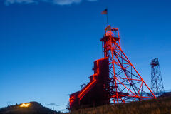 A red mining tower against a blue sky at twilight in Butte, Montana