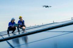 Technicians_working_with_a_drone_on_solar_panels