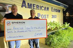David Miller, owner of Spherion Fort Myers, presents a check for $1,000 to the local American Legion post as part of the 2022 Community Giveback.