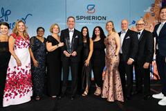 Spherion executives and franchisees dressed up on a stage to accept an award