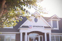 Photo of a Spherion office surrounded by trees and sunlight