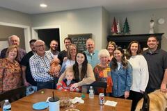 A family smiles for the camera inside a home