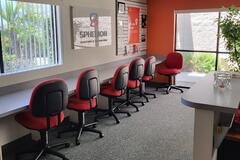 Photo of an office interior with six chairs pulled up to a counter