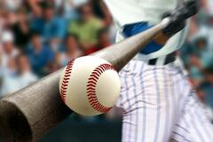 Baseball connecting with a baseball bat