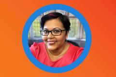 Orange background with a blue circular frame in the enter featuring a picture of a smiling Black professional woman in glasses.
