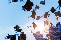 Graduation Caps being thrown in the air
