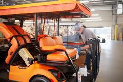 Final touches on a golf cart