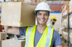man in warehouse holding a box