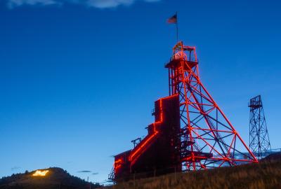 A red mining tower against a blue sky at twilight in Butte, Montana