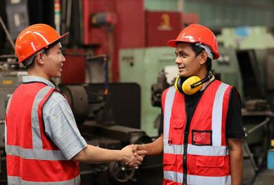 Maintenance_Supervisors_shaking_hands_wearing_orange_safety_vests
