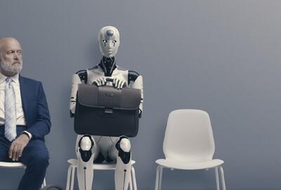 A man and an AI robot sitting on chairs in a gray waiting area