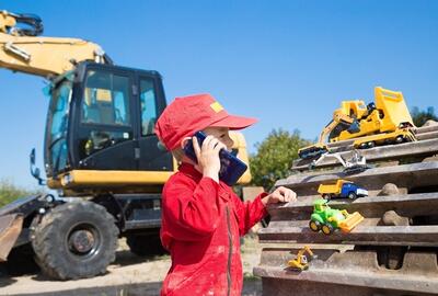 Boy with construction toys on site
