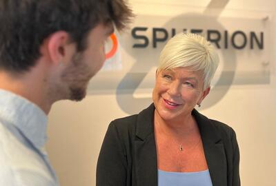 A professional woman talking with a colleague