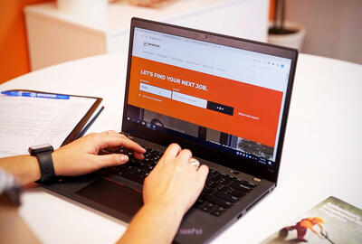 Build a Winning Franchise Marketing Strategy A woman typing on a laptop