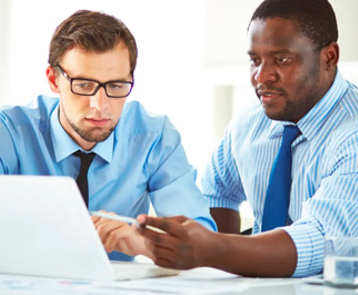 Two financial managers reviewing paperwork together