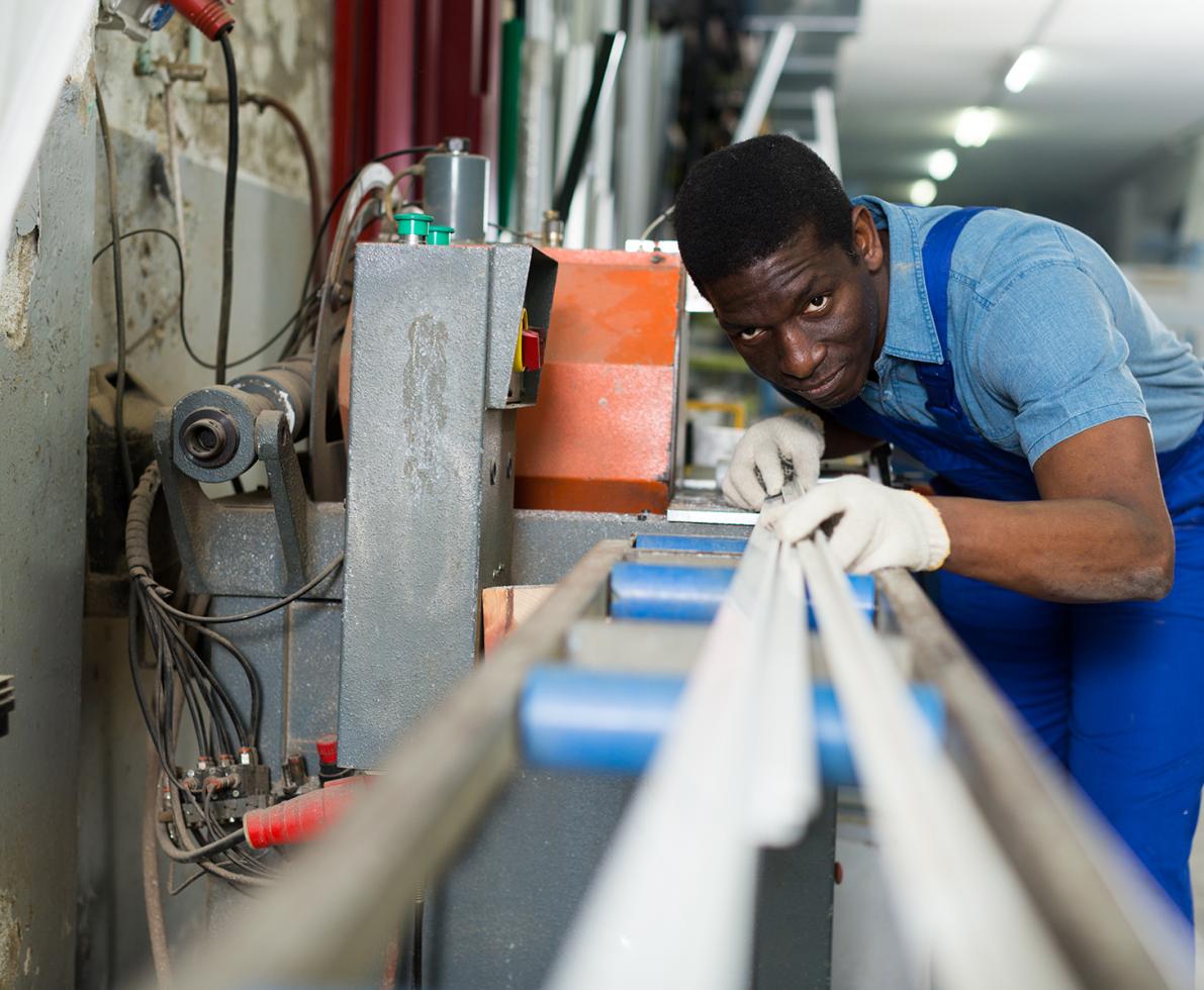 Light indutrial staffing worker measuring a beam