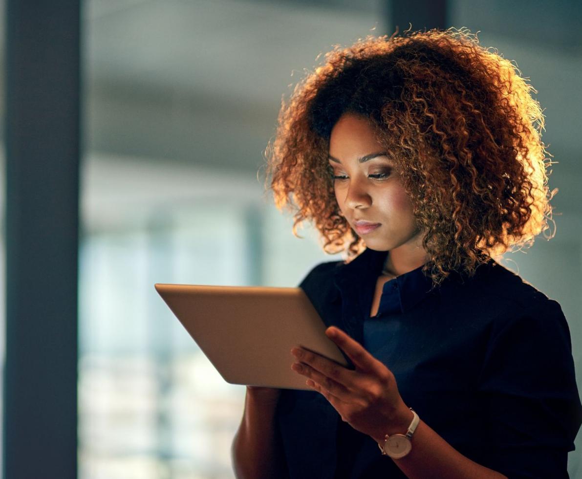 Healthcare staffer reading material on a tablet