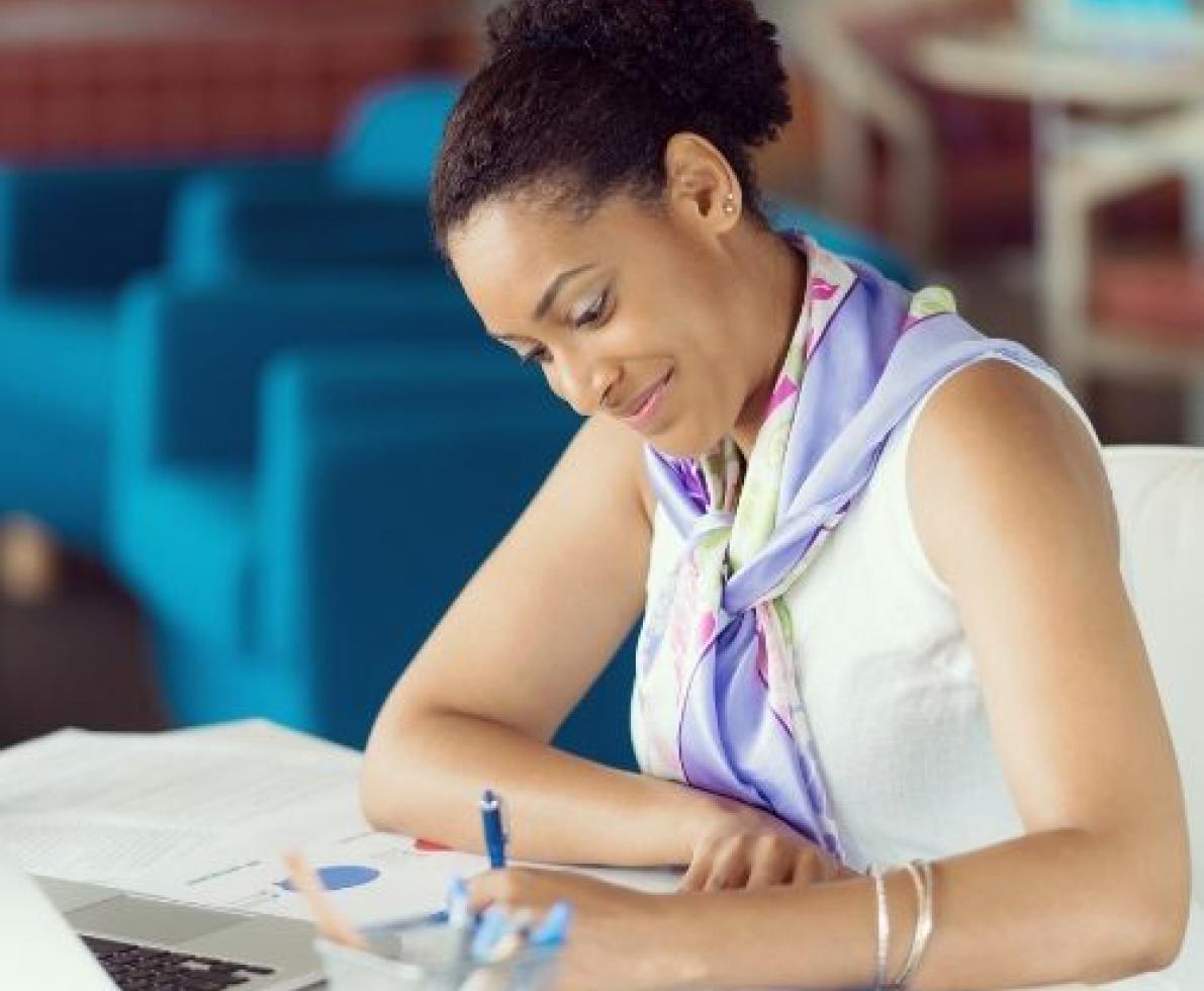 Woman smiling and writing