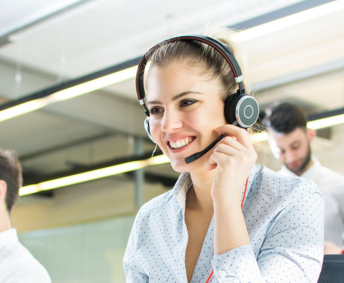 Woman smiling while talking on a headset