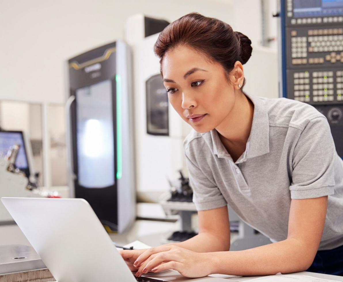 Engineering staffing professional looking over a document on a laptop