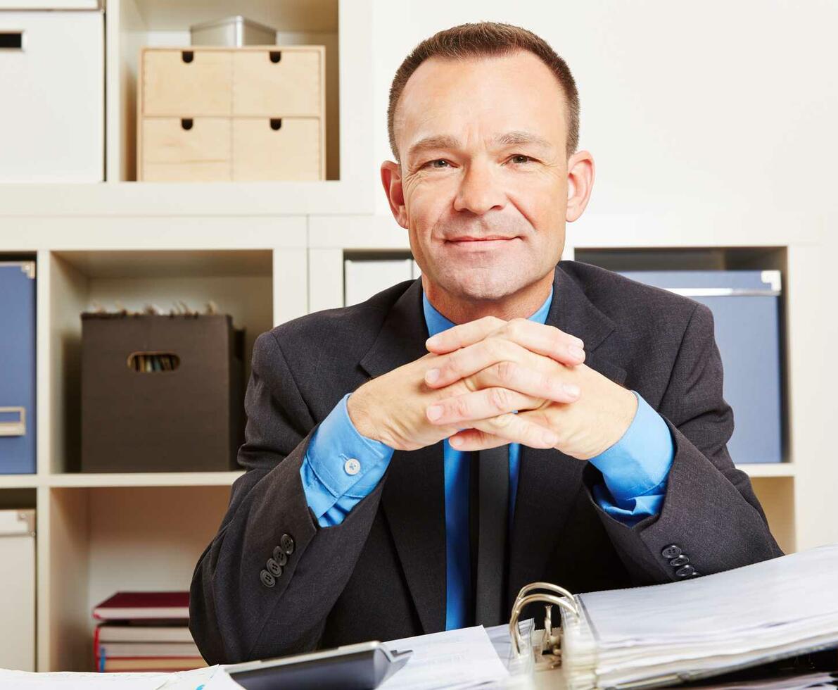 Accounting_clerk_sitting_at_his_desk