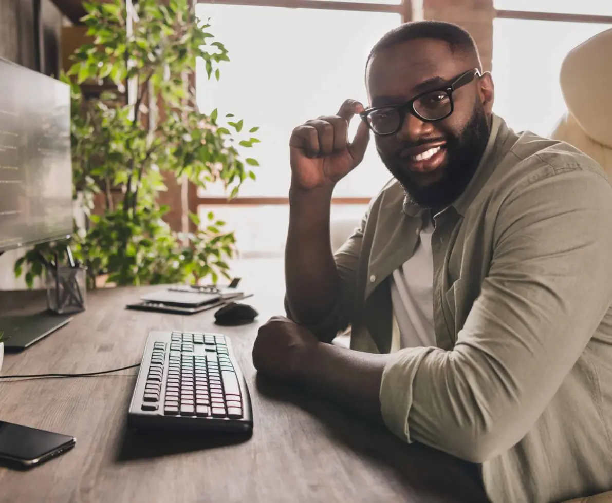 Male_web_developer_sitting_at_his_desktop_computer