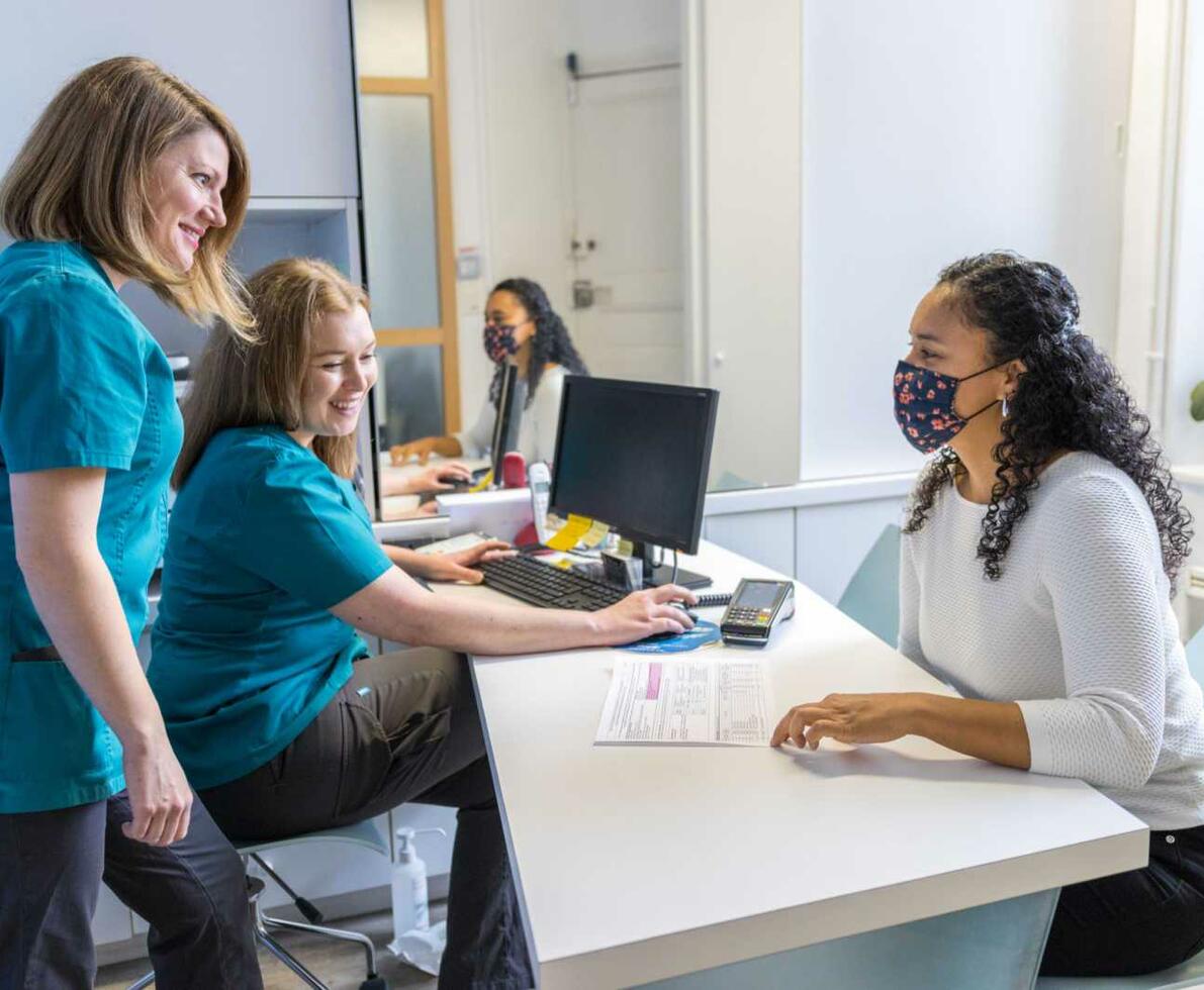 Office_managers_in_dental_office_talking_with_a_patient_1600_x_1067