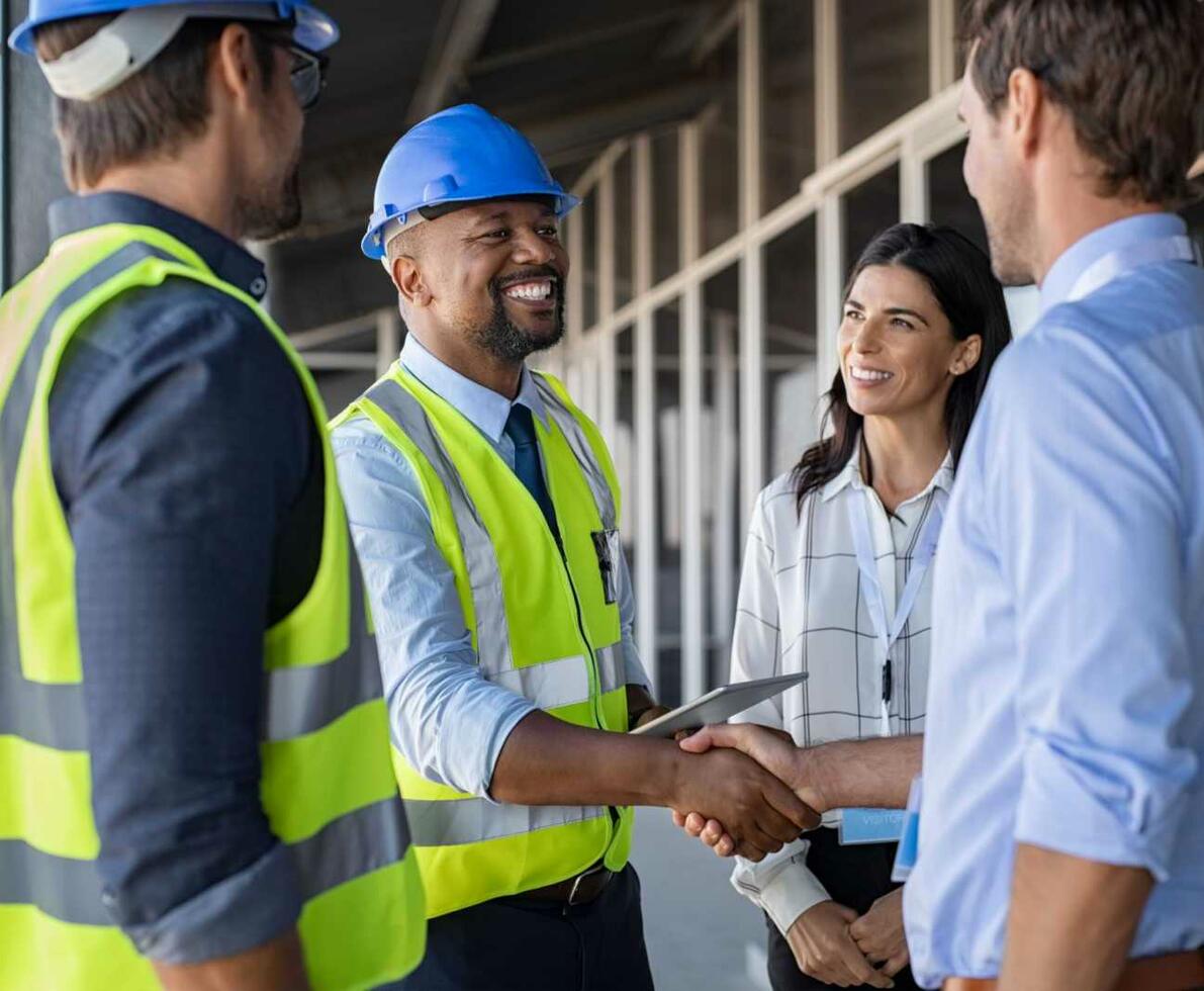 Supervisor_-_Smiling_supervisor_shaking_hands_at_construction_site Supervisor_-_Smiling_supervisor_shaking_hands_at_construction_site