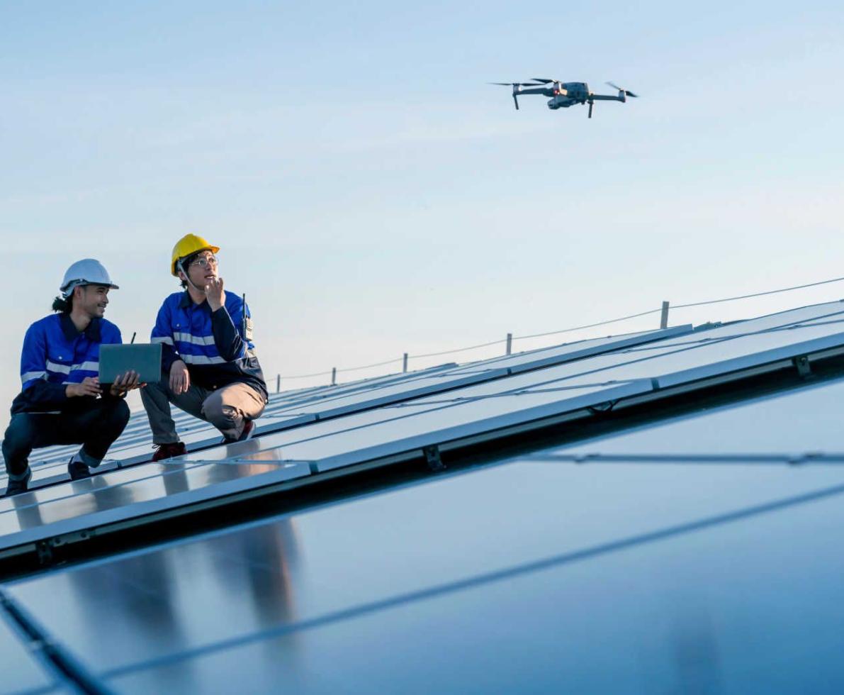 Technicians_working_with_a_drone_on_solar_panels
