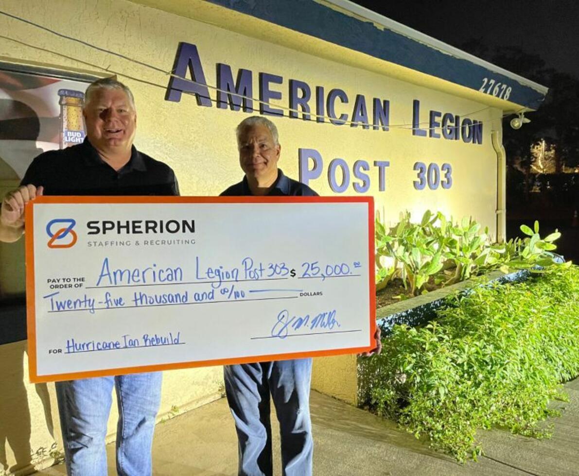 David Miller, owner of Spherion Fort Myers, presents a check for $1,000 to the local American Legion post as part of the 2022 Community Giveback.