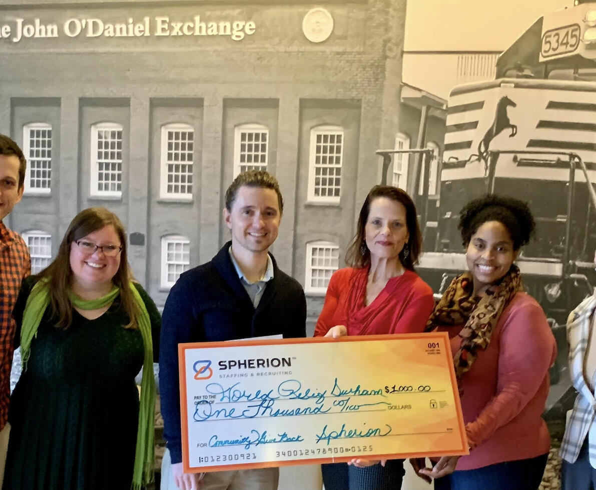 The Spherion Raleigh staff presents a check for $1,000 to World Relief organization in Raleigh, North Carolina