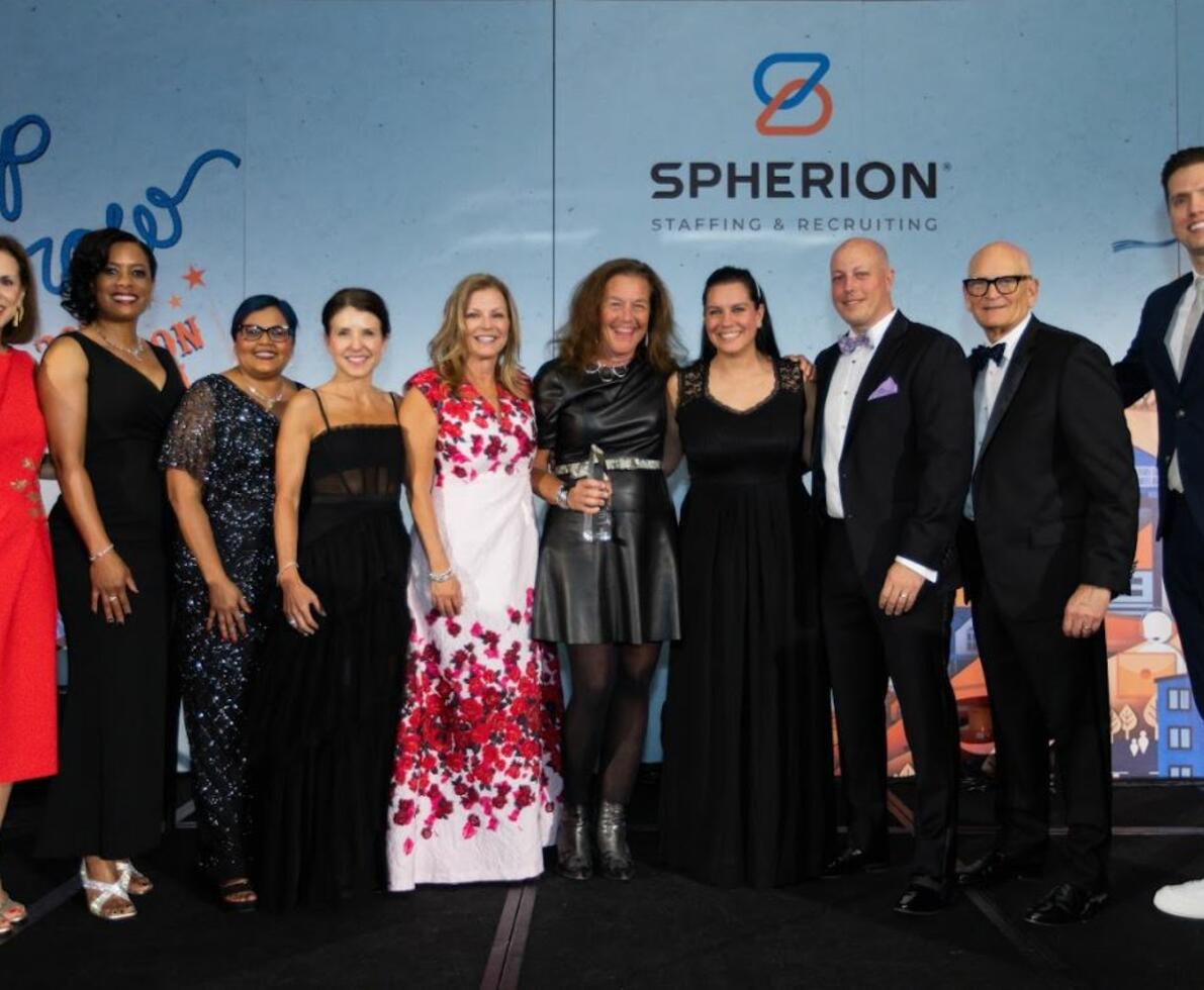 A group of people on a stage to accept an award