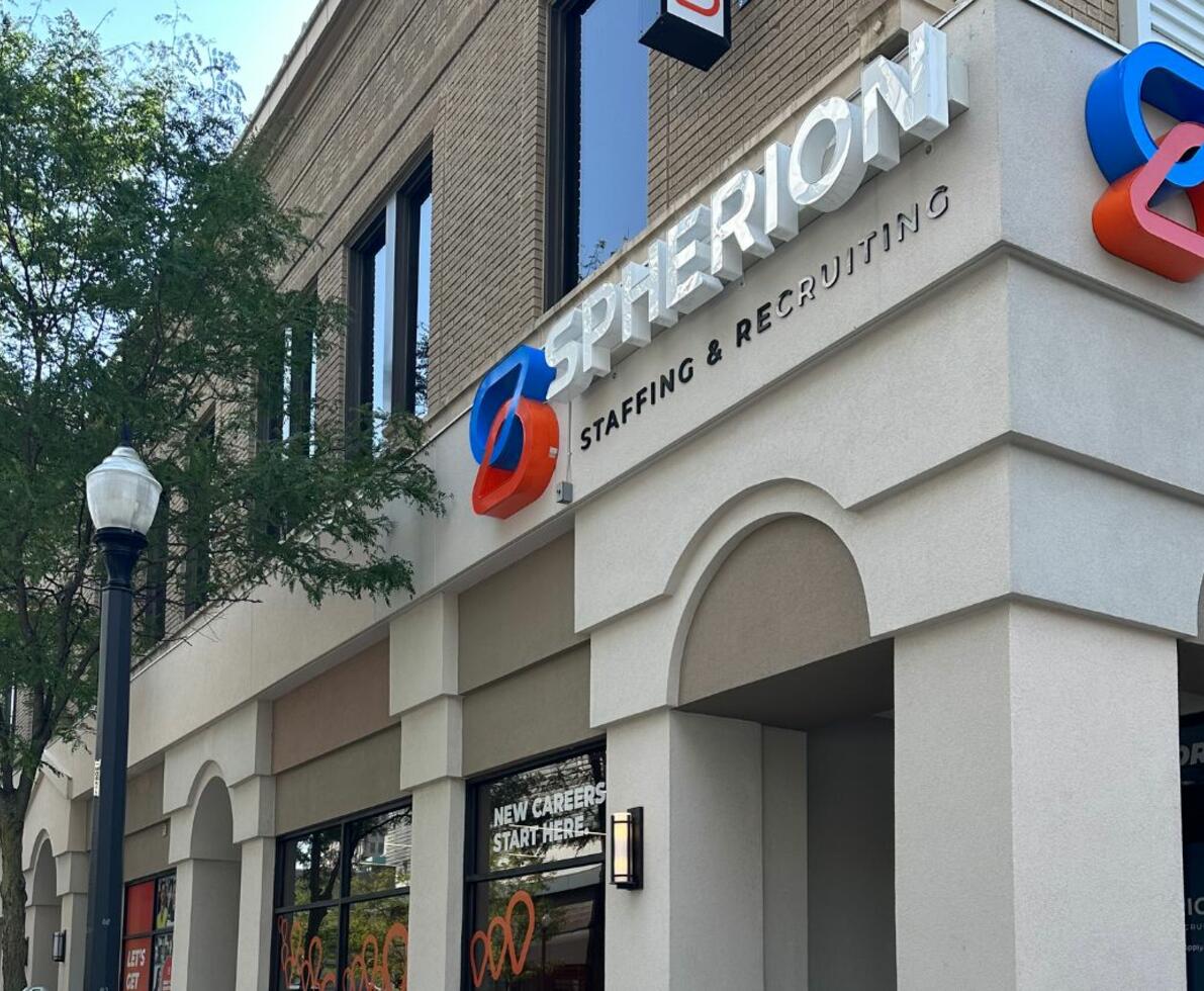 Photo of a tan office building on a street corner