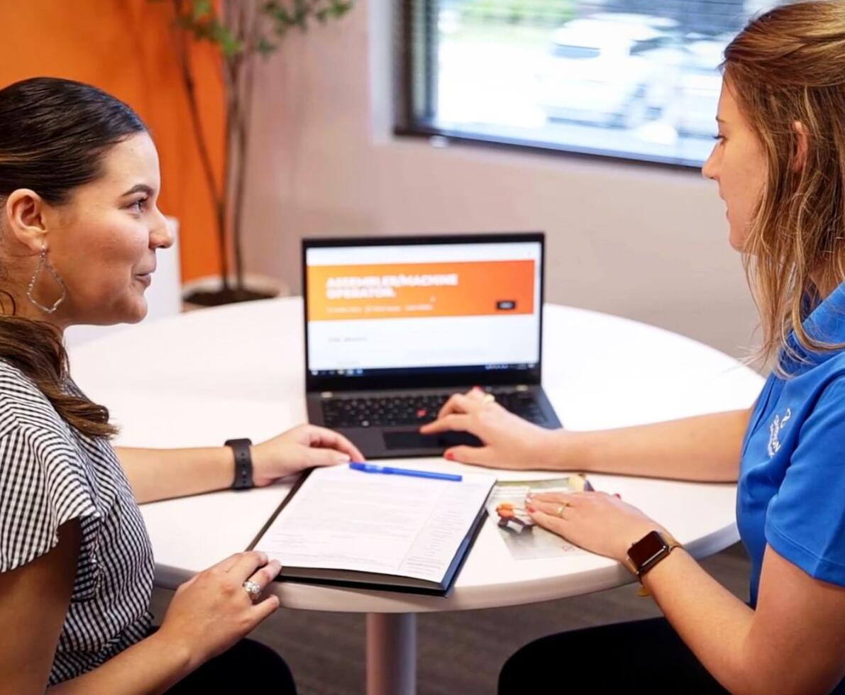 Two women discussing a job posting